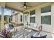 Covered patio featuring outdoor seating, ceiling fan, and tranquil backyard views at 7058 Cloer Ct, Charlotte, NC 28214