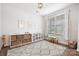 Well-lit playroom with shelving, decorative prints, and a cozy play area for children at 7058 Cloer Ct, Charlotte, NC 28214