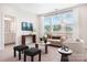 Upstairs sitting area featuring large windows, a sofa, and a media center at 7058 Cloer Ct, Charlotte, NC 28214