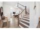 Elegant staircase with wood treads, white risers, and an open floor plan flowing into the living room at 7058 Cloer Ct, Charlotte, NC 28214
