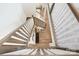 Overhead view of the staircase highlighting the transition from hardwood to carpet on the upper level at 7058 Cloer Ct, Charlotte, NC 28214