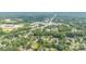 A wide aerial view of a neighborhood surrounded by lush greenery and various community amenities at 7224 Newell Acres Dr, Charlotte, NC 28215