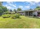 A well-maintained backyard with a vegetable garden, screened porch, and a grey pick-up truck at 7224 Newell Acres Dr, Charlotte, NC 28215