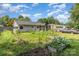 An expansive backyard with lush green grass, raised garden beds, and a grey pick-up truck at 7224 Newell Acres Dr, Charlotte, NC 28215