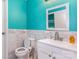 This bathroom has a blue accent wall and a marble tile backsplash behind the sink and toilet at 7224 Newell Acres Dr, Charlotte, NC 28215