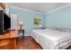 Comfortable bedroom featuring a large window, hardwood floors, and light blue walls at 7224 Newell Acres Dr, Charlotte, NC 28215