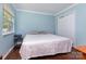 Inviting bedroom with blue walls, wood floors, and a view of the backyard at 7224 Newell Acres Dr, Charlotte, NC 28215