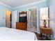 Bedroom with an ensuite bathroom and wood dresser at 7224 Newell Acres Dr, Charlotte, NC 28215