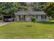 Charming single-story home with well-maintained lawn, carport and patriotic curb appeal at 7224 Newell Acres Dr, Charlotte, NC 28215