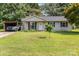 Charming single-story home with well-maintained lawn, carport and patriotic curb appeal at 7224 Newell Acres Dr, Charlotte, NC 28215