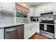 Bright kitchen with stainless steel appliances, white cabinets, and hardwood floors at 7224 Newell Acres Dr, Charlotte, NC 28215