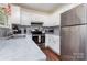 Spacious kitchen showcasing stainless steel appliances, marble counters, and ample cabinet space at 7224 Newell Acres Dr, Charlotte, NC 28215