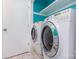The laundry room has marble tile floors, a washer and dryer, and blue accent paint at 7224 Newell Acres Dr, Charlotte, NC 28215