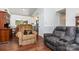Inviting living room featuring vaulted ceiling, laminate flooring, and comfortable reclining seating at 7224 Newell Acres Dr, Charlotte, NC 28215