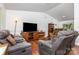 Inviting living room featuring vaulted ceiling, laminate flooring, and comfortable reclining seating at 7224 Newell Acres Dr, Charlotte, NC 28215