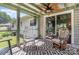 A cozy screened porch with rocking chairs and sliding glass doors at 7224 Newell Acres Dr, Charlotte, NC 28215