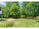 Well-manicured backyard with lush lawn, mature trees, and privacy fence at 7355 Drury Ln, Denver, NC 28037