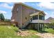 Brick home with a backyard, wood fence, screened porch, and well-maintained landscaping at 7355 Drury Ln, Denver, NC 28037