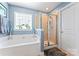 Relaxing bathroom with a soaking tub and glass-enclosed shower at 7355 Drury Ln, Denver, NC 28037