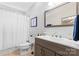 Well-lit bathroom with a modern vanity, a large mirror, and a shower with curtain at 7355 Drury Ln, Denver, NC 28037