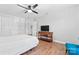 Bright bedroom featuring hardwood floors, a ceiling fan, and neutral wall paint at 7355 Drury Ln, Denver, NC 28037