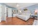 Serene bedroom with blue walls, hardwood floors, and a comfortable queen-size bed at 7355 Drury Ln, Denver, NC 28037