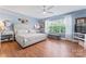 Charming bedroom with a large window, hardwood floors, and a stylish queen-size bed at 7355 Drury Ln, Denver, NC 28037