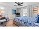 Comfortable bedroom features wood floors, ceiling fan, large windows, and soft lighting at 7355 Drury Ln, Denver, NC 28037