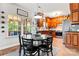 Cozy kitchen nook with a round table, black chairs, and a view of the main kitchen area and outdoor seating space at 7355 Drury Ln, Denver, NC 28037