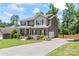 Lovely two-story home with an extended driveway leading to an attached garage, complemented by a well-maintained lawn at 7355 Drury Ln, Denver, NC 28037