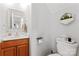 Stylish half bathroom with wooden vanity, modern fixtures, and decorative elements at 7355 Drury Ln, Denver, NC 28037