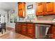 Bright kitchen showcasing warm cabinetry, modern stainless steel appliances, and a window overlooking the lush backyard at 7355 Drury Ln, Denver, NC 28037
