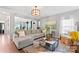 Bright living room featuring a large grey sectional sofa and stylish decor at 7355 Drury Ln, Denver, NC 28037