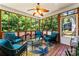 Cozy sunroom with wood trim, ceiling fan, and beautiful views of the outdoors at 7355 Drury Ln, Denver, NC 28037