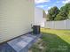 View of the backyard featuring a well-maintained lawn and exterior of the home with AC unit at 8516 Paw Valley Ln, Charlotte, NC 28214