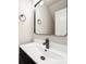 Half bathroom with white vanity, black hardware and black framed mirror at 8516 Paw Valley Ln, Charlotte, NC 28214