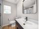 Bathroom featuring a modern vanity, a sleek faucet, and a stylish mirror at 8516 Paw Valley Ln, Charlotte, NC 28214