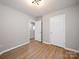 Bedroom showcasing wood-look floors, neutral walls, and doors for easy access at 8516 Paw Valley Ln, Charlotte, NC 28214