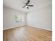 Bright and airy bedroom with wood floors, a ceiling fan, and a large window for natural light at 8516 Paw Valley Ln, Charlotte, NC 28214