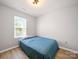 Cozy bedroom featuring neutral walls, wood plank floors, and a bright window at 8516 Paw Valley Ln, Charlotte, NC 28214