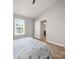 Comfortable bedroom with a large window, wood plank floors, and easy access to a private bathroom at 8516 Paw Valley Ln, Charlotte, NC 28214