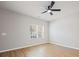 Comfortable bedroom with hardwood floors, a ceiling fan, and a window for natural light at 8516 Paw Valley Ln, Charlotte, NC 28214