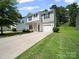 Inviting two-story home featuring a well-manicured lawn and an attached one-car garage at 8516 Paw Valley Ln, Charlotte, NC 28214