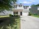 Two-story home with an attached one car garage and long driveway at 8516 Paw Valley Ln, Charlotte, NC 28214