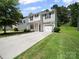 Two-story home with an attached one car garage and long driveway at 8516 Paw Valley Ln, Charlotte, NC 28214