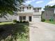 Charming two-story home featuring a welcoming front porch and a well-maintained lawn at 8516 Paw Valley Ln, Charlotte, NC 28214