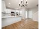 Inviting dining area features hardwood flooring and views into the modern kitchen at 8516 Paw Valley Ln, Charlotte, NC 28214