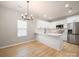 Bright kitchen features white cabinets, quartz countertops, and stainless steel appliances at 8516 Paw Valley Ln, Charlotte, NC 28214
