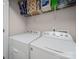 Functional laundry area equipped with a washer, dryer, and storage shelving at 8516 Paw Valley Ln, Charlotte, NC 28214