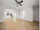 Open-concept living area with hardwood floors and view into the kitchen at 8516 Paw Valley Ln, Charlotte, NC 28214
